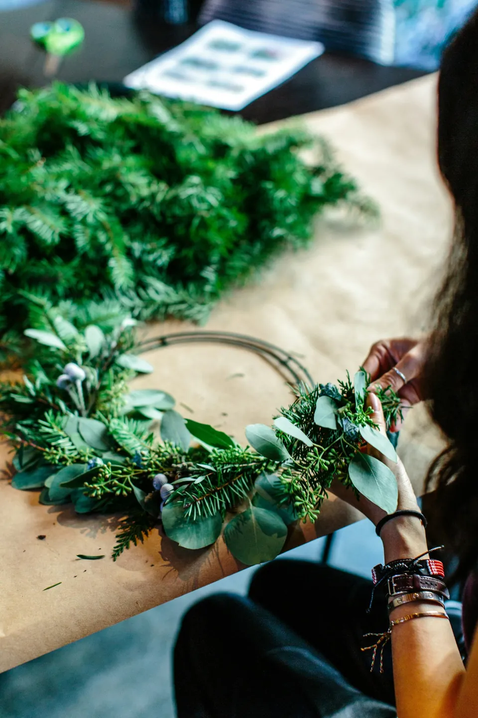 The florist&rsquo;s photo of hands building a wreath