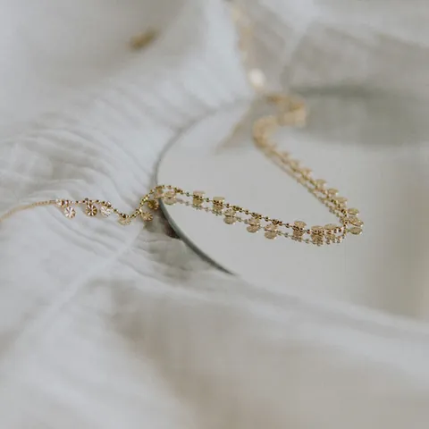 Gold chain necklace with small disc charms