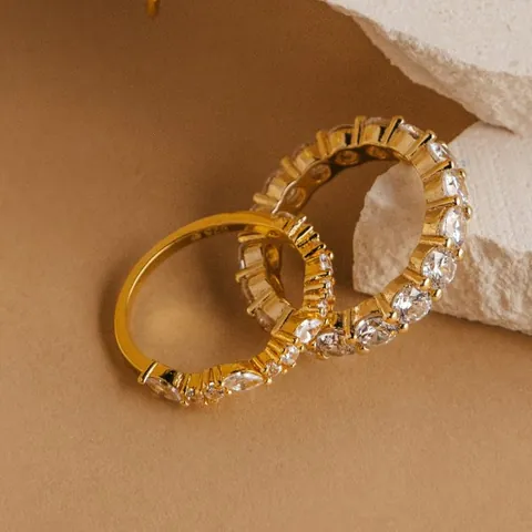 Two gold rings set with clear stones