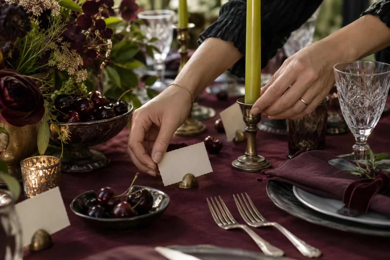 A wedding stylist adjusting place cards and candles